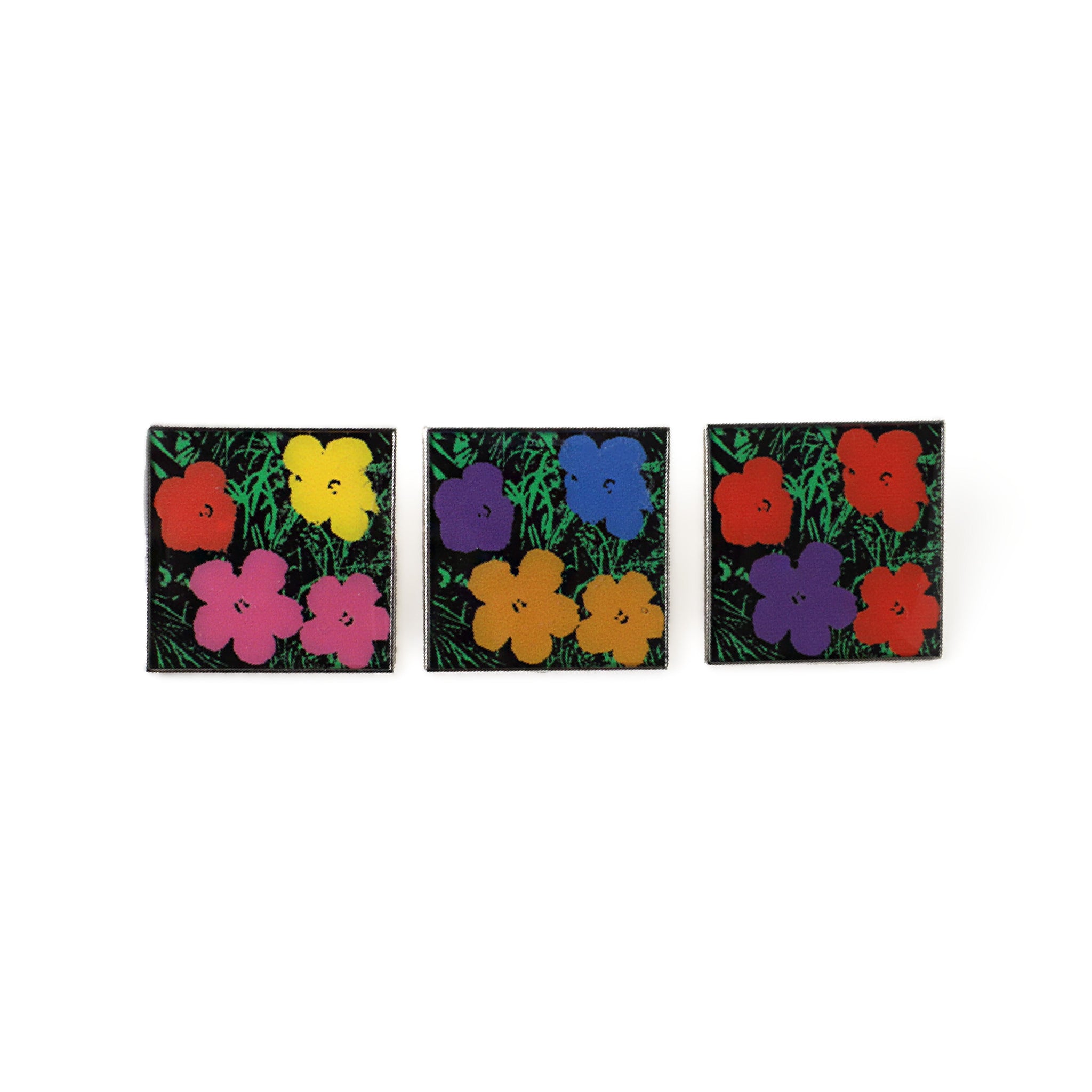 Three square stickers with colorful floral designs on a white background