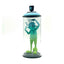 Green character figurine inside a transparent cylindrical container with a black lid on a white background